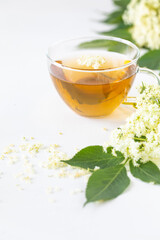 Tea and syrup from elderberry flowers Sambucus nigra on a white background. Copy space