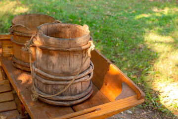 Naklejka premium wooden bucket old and weathered, traditional container for storing water