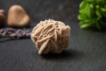 A closeup view of a desert rose selenite rock crystal, in a still life setting.