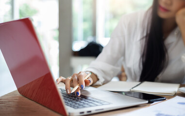 Young asian businesswoman using laptop working and meeting online from home