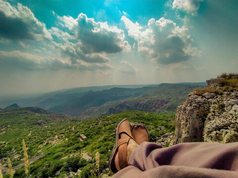 A Man Watching The Hills & Clouds