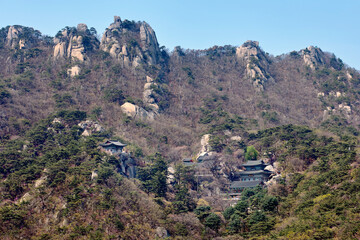 View of a temple on steep and lush hillside at the Bukhansan National Park in Seoul, South Korea.