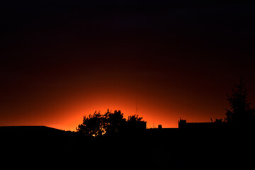  colorful sunset with red sky and trees and clouds