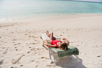 Full size above view photo of beautiful lady lying lounge chair azure water exotic resort empty desert beach no people sunbathing relaxing wear specs red bodysuit enjoy sun rays outside