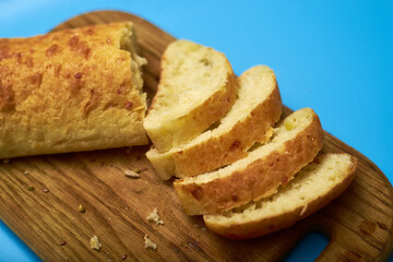 Sliced ciabatta on a blue background.