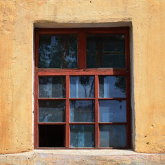 Fototapeta na wymiar Old vintage window on yellow wall