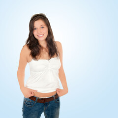 Closeup portrait of a beautiful girl wearing sunglasses, blue jeans and white top in front of blue background