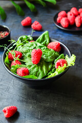 raspberries and lettuce salad, spinach, arugula Menu concept serving size. food background top view copy space healthy eating 