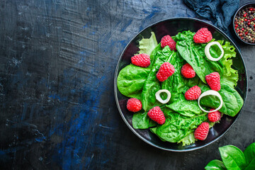 raspberries and lettuce salad, spinach, arugula Menu concept serving size. food background top view copy space healthy eating 