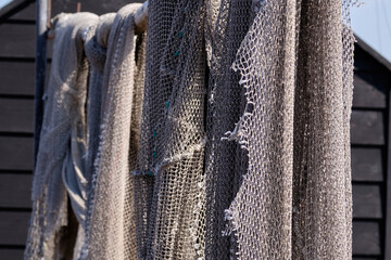 Fishing nets hang to dry in the sun, still lifes and objects. Fishermen, fishing net