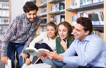 Fototapeta premium students sitting on floor in library in campus and preparing together for exams
