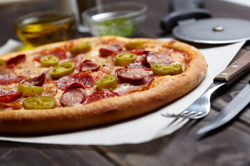 tasty pizza on the wooden background