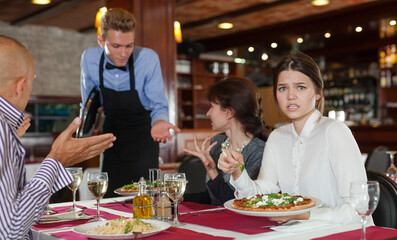 Dissatisfied guests complaining to waiter