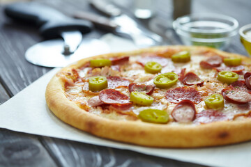 tasty pizza on the wooden background