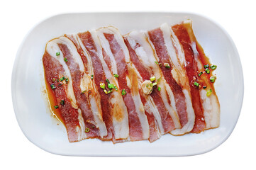 pork bacon sliced top with sauce served on white plate dish