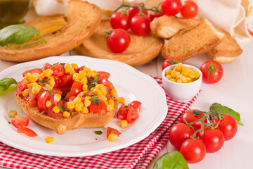 Friselle with tomatoes and mais.
