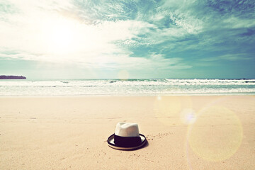 Fototapeta na wymiar vintage style ocean sea beach clean clear sand with straw hat