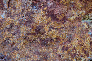colored rocky stones of natural origin, background for walls and wallpapers, highlighted texture of the material, natural color blocks