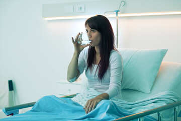 Female patient drinking a glass of water