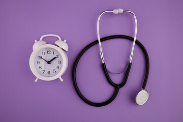 Time is important in life concept. Stethoscope kit and alarm clock.