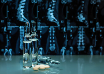 Anesthetizing drugs and medicines in ampoules, tablets in the treatment of diseases of the back - hernia, scoliosis, osteochondrosis against the background of spinal tomography print.