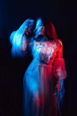 blurry portrait of a young girl with mental disorders in a dress on a dark background