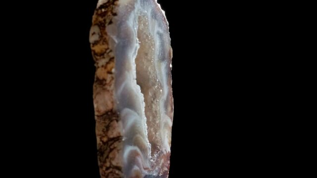 Agate with quartz. Agate rotates around its axis on a black background.