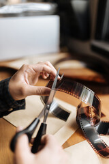 Male hands cutting vintage film 35mm