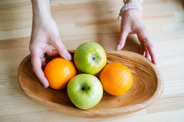 young white girl holding fruit in her hands, fruit on the table