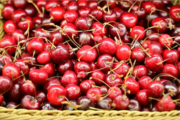 Photo of red cherry sweet berries ready for sale on a tray