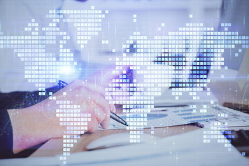 Double exposure of hands and notepad with business icons.