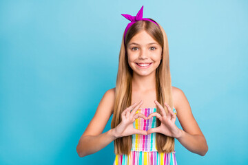 Portrait of positive cheerful child girl make heart finger shape show lover sign feelings wear good look bright outfit isolated over blue color background