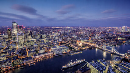 London city area skyline and buildings aerial photograph at night showing offices and office lights with Tower Bridge, the Tower of London and River Thames
