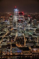 Obraz premium London city area skyline and buildings aerial photograph at night showing offices and office lights. Financial and banking district. 