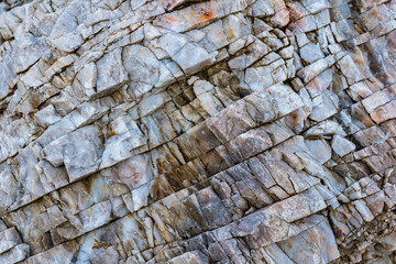 colored rocky stones of natural origin, background for walls and wallpapers, highlighted texture of the material, natural color blocks