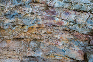 colored rocky stones of natural origin, background for walls and wallpapers, highlighted texture of the material, natural color blocks