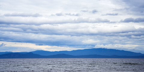 Panoramic view of the ocean bay with cloudy sky near Bamfield in Canada.