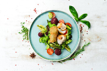Salad with salted fish, cheese and vegetables. Top view. Rustic style.