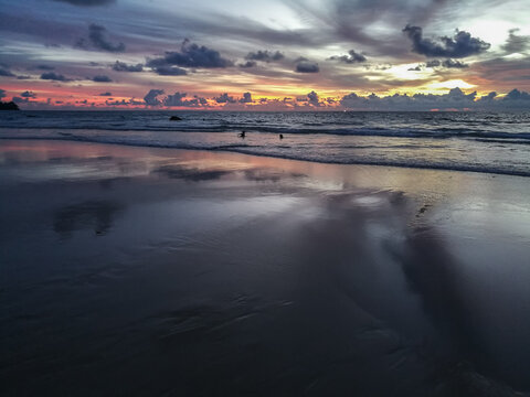 Incredible sunset on the asian coast. Enjoying the sea evening view with your loved one. Sunrise at andaman sea. Romantic weekend on the beach. Image with noise effect and toning