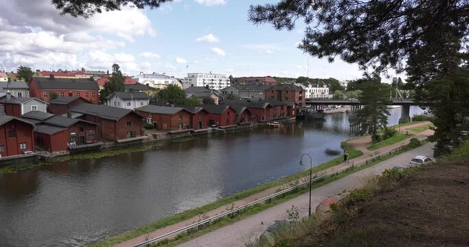 4K video of Porvoo vintage red wooden buildings, Porvoo Cathedral, yachts and boats in Porvoonjoki River near town center on sunny summer day in Finland, northern Europe