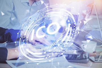 Crypto currency theme hologram with businessman working on computer on background. Concept of blockchain. Multi exposure.