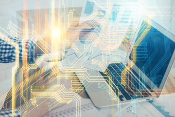 Double exposure of world map hologram with man working on computer on background. Concept of worldwideweb.