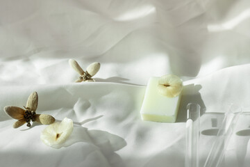 organic brown natural flower with white soap on soft fabric health well-being or wellness soft fabric background