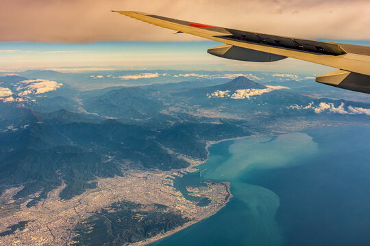 Aerial airplane view of Shizuoka and Suruga Bay, with iconic Mount Fuji in the distance, Japan