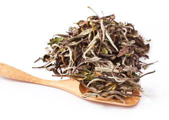 Bai Mu Dan (White Peony) chinese white tea in a scoop isolated on a white background.