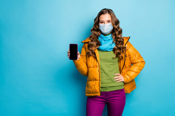 Portrait of her she nice attractive lady wearing safety mask showing device display news...