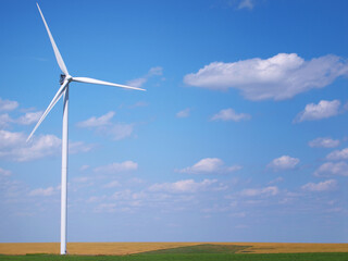 Wind turbine in the field and blue sky