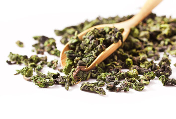 Tieguanyin chinese Oolong tea and wooden scoop isolated on a white background