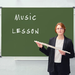 School teacher and the text "music lesson" written on the blackboard, the concept of learning to play musical instruments