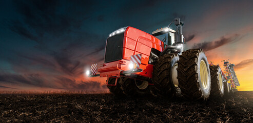 Red tractor on a agricultural field 

